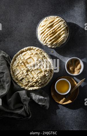 Two pies with lattice crust on dark neutral background Stock Photo