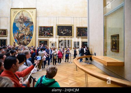 People taking photos of Mona Lisa by Leonardo da Vinci at Louvre Museum in Paris, France Stock Photo