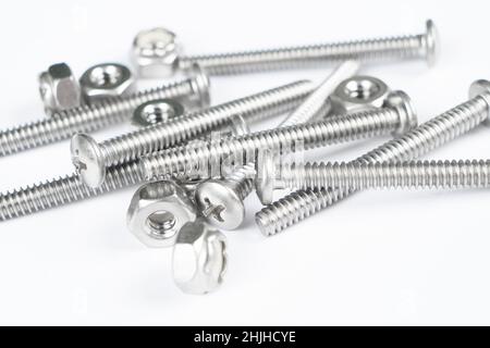 Metal bolts and nuts in a row background. Chromed screw bolts and nuts isolated. Steel bolts and nuts pattern. Set of Nuts and bolts. Tools for work. Stock Photo