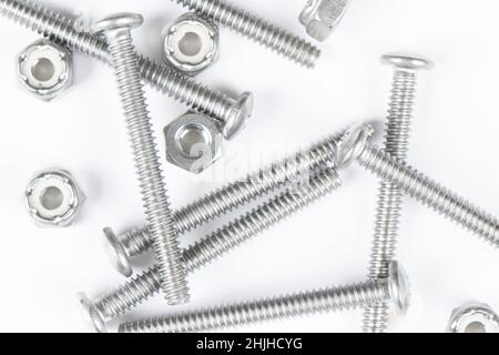 Metal bolts and nuts in a row background. Chromed screw bolts and nuts isolated. Steel bolts and nuts pattern. Set of Nuts and bolts. Tools for work. Stock Photo