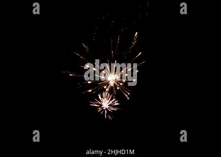 Fireworks in the night sky. Texture of colored lights background. Festive salute lights attract. Large festive firework on a black background Stock Photo