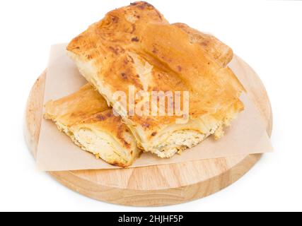 Placinta cake filled with a soft cheese as a romanian cuisine. Isolated on a white background. Stock Photo