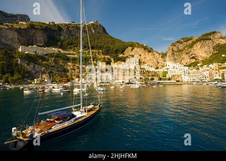 Yacht in the sea against rocky coast, Amalfi Stock Photo