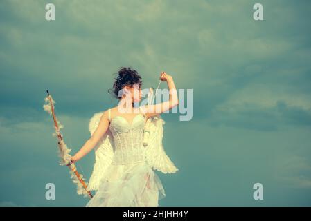 Valentin angel teen girl with wings. Valentines teenager girl with bow arrow. Stock Photo