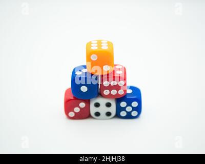 Mixed color of dice arranged in pyramid tower isolated on white background Stock Photo