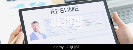 Manager examines applicant electronic questionnaire on tablet Stock Photo