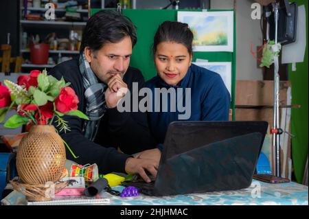 the man and woman are doing their office work in home . Stock Photo
