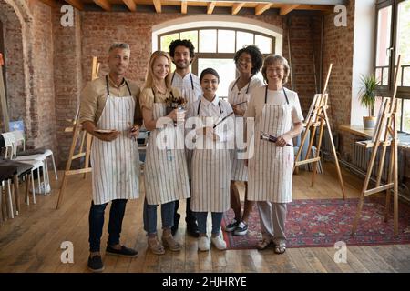 Multiethnic group of diverse art school students in artistic studio Stock Photo