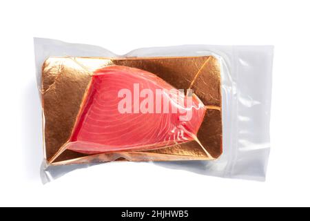 Fresh tuna fillet vacuum packed. Fish steak on a white background. Red fish textured steak isolated. Stock Photo