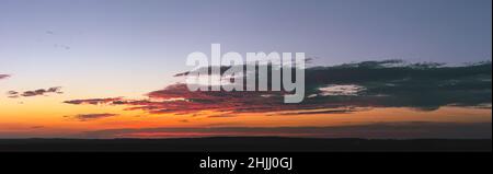 Bright colorful sky after sunset with several clouds. The sky in the last minutes before darkness Stock Photo