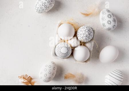Easter eggs with black and white pattern and feathers Stock Photo