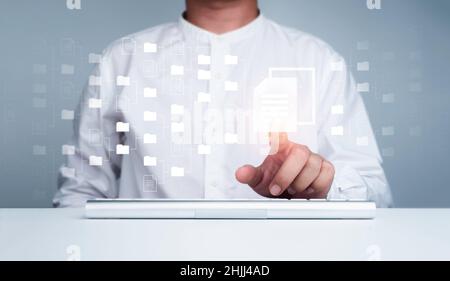 Document management. Cloud computing technology. Document file information and folder icons and man finger touching on virtual screen computer, online Stock Photo