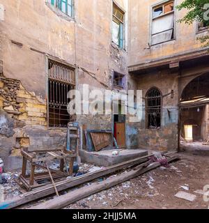 Day shot of old abandoned stone bricks wall with grunge broken wrought iron windows and doors Stock Photo