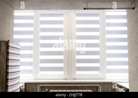 Windows with open modern horizontal blinds indoors, closeup. Stock Photo