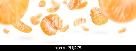 A large set of mandarin slices isolated on a white background falling down casting a shadow. Separate tangerine slices to insert into a project or Stock Photo