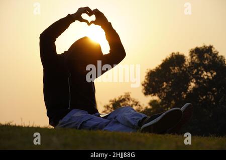 boy giving heart symbol shape with hands. Stock Photo