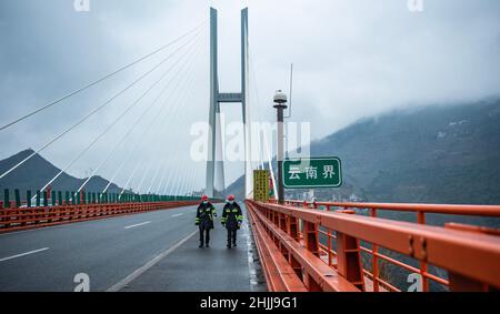 Liupanshui. 29th Jan, 2022. Maintenance workers carry out an inspection on the Beipanjiang Bridge in southwest China's Guizhou Province, Jan. 29, 2022. Sitting over 565.4 meters above a valley, the Beipanjiang Bridge has been certified as the world's highest bridge by the Guinness World Records. Spanning 1,341.4 meters, the bridge links Duge Township of Liupanshui in southwest China's Guizhou with Puli Township of Xuanwei in southwest China's Yunnan Province. Credit: Tao Liang/Xinhua/Alamy Live News Stock Photo