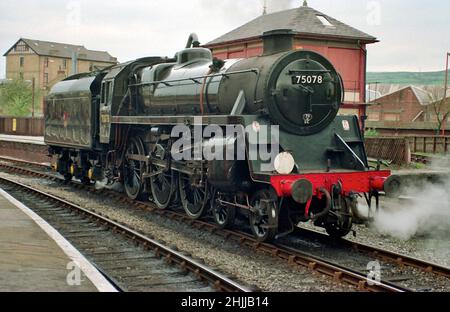 British Railways Standard Class 4MT 4-6-0 tender steam locomotive awaits the next train at Keighley station on the KWVR in the 1990's Stock Photo