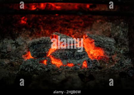 Glowing embers in a wood fire on a fireplace Stock Photo