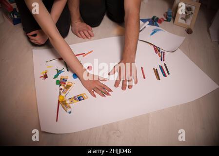 Two lovers draw with paints. Hands are covered with paint. Love . Stock Photo