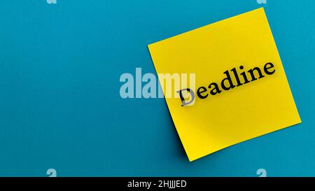 Top view of text - Deadline on sticky note with blue background. Business concept. Stock Photo