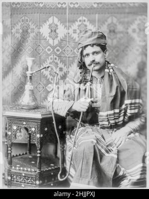 Man Smoking Water Pipe - 1901 Stock Photo