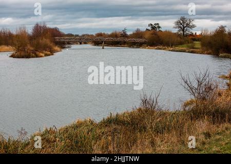 Dorney, UK. 29th January, 2022. A footbridge across the Jubilee River. The Jubilee River is a 11.6km hydraulic channel constructed between 1995-2006 to alleviate flooding to areas in and around Maidenhead, Windsor and Eton. Credit: Mark Kerrison/Alamy Live News Stock Photo