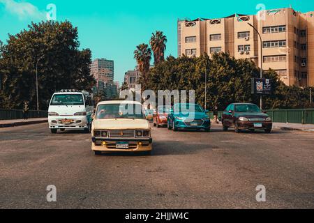 Cairo Egypt December 2021 View of four cars driving in paralel in downtown cairo, crossing over the bridge on river nile. Concepts of traffic jams and Stock Photo