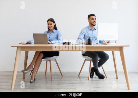 Portrait Of Smiling Colleagues Working At Office Together Stock Photo