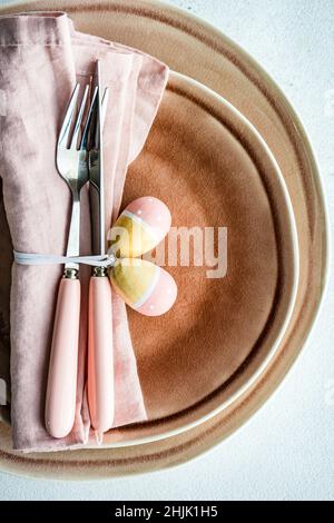 Overhead view of an Easter place setting with painted Easter egg decorations Stock Photo