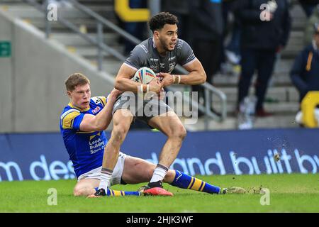 Leeds Rhinos' Morgan Gannon is tackled by Wigan Warriors' Sam Walters ...