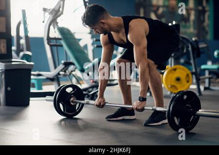 Portrait Of Muscular Middle Eastern Guy Making Deadlift Workout At Modern Gym Stock Photo