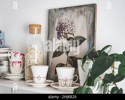 Beautiful picture of a flower and a houseplant standing on a table. Close-up, indoor Stock Photo