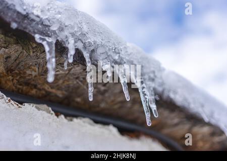 Small Icicles hang from the wooden roof. Stock Photo