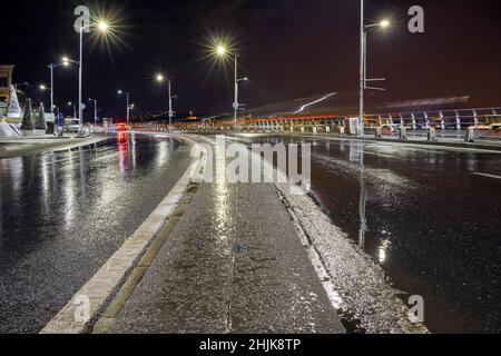 The empty wet road at rainy night in the center of Istanbul city. Stock Photo