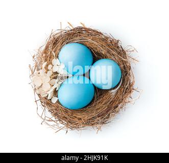 The nest with Easter pink eggs is isolated on a white background. Side view. Stock Photo