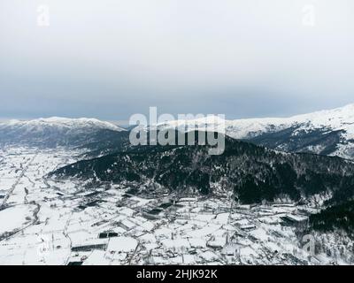 Aerial view of Frozen Golcuk lake and some mountains with Bozdag mountain at Odemis Izmir in winter season. Stock Photo