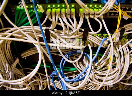 Cables in server rack. Keywords: wires internet configuration complicated personal data phishing equipment consumption technical electronic problem ce Stock Photo