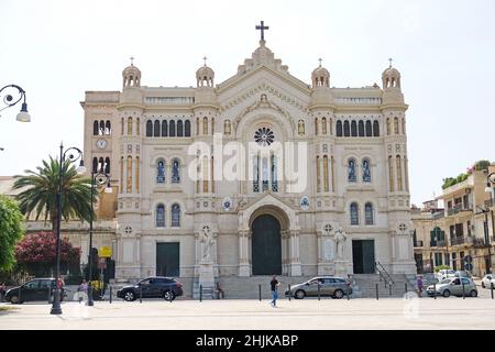 People walking in the square in front of the cathedral. Reggio Calabria, Italy - July 2022 Stock Photo