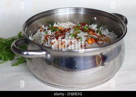 Cottage cheese Biryani or Paneer Biryani inside Biryani pot. Steamed and spiced basmati rice layered with creamy cottage cheese gravy made with cottag Stock Photo