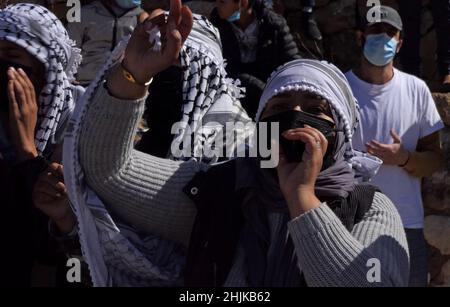 JERUSALEM, ISRAEL - JANUARY 30: Bedouin women wearing traditional Arabian headdress Keffiyeh shout slogans during a demonstration in front of the Israeli prime minister's office against Israel's land control in the Negev desert and to demand legalization of unrecognized Bedouin villages on January 30, 2022 in Jerusalem, Israel. Credit: Eddie Gerald/Alamy Live Stock Photo