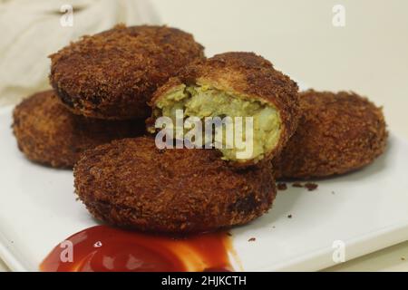 Deep fried Chicken Cutlets. A flat croquette of minced meat covered in bread crumbs and fried. Shot on white background. Stock Photo