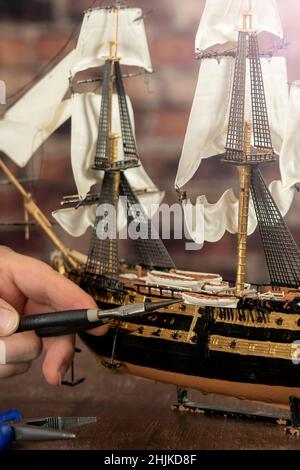 Model Ship Building handcraft on table with different materials Stock Photo