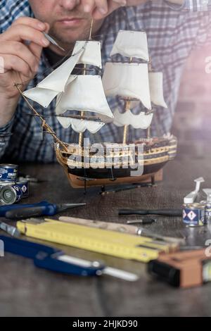 Model Ship Building handcraft on table with different materials Stock Photo