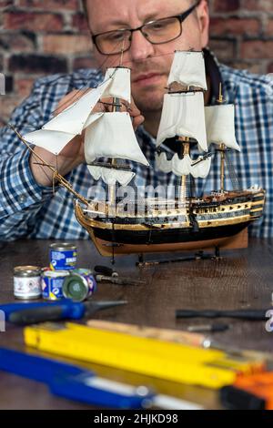 Model Ship Building handcraft on table with different materials Stock Photo