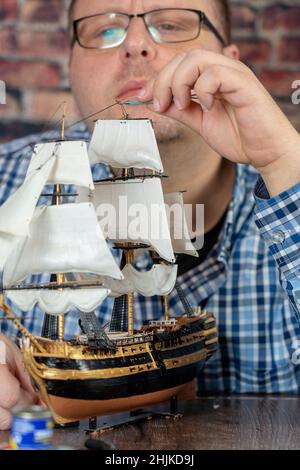 Model Ship Building handcraft on table with different materials Stock Photo