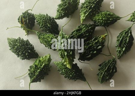 Bitter melon, also known as bitter gourd or pavakka or karela is a tropical vine that belongs to the gourd family with bitter taste. Shot on white bac Stock Photo