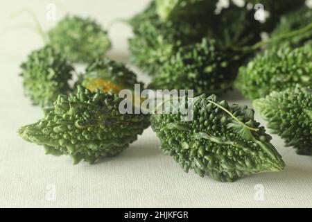 Bitter melon, also known as bitter gourd or pavakka or karela is a tropical vine that belongs to the gourd family with bitter taste. Shot on white bac Stock Photo