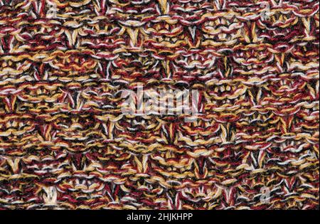 Wool knit color swatch sample pattern of several different colored woolen strands of red, black, white and yellow. Stock Photo