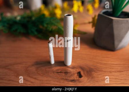 IQOS, a Tobacco heating system  by Philip Morris - tobacco product technologies - hybrid heets cigarette on a wooden background Stock Photo